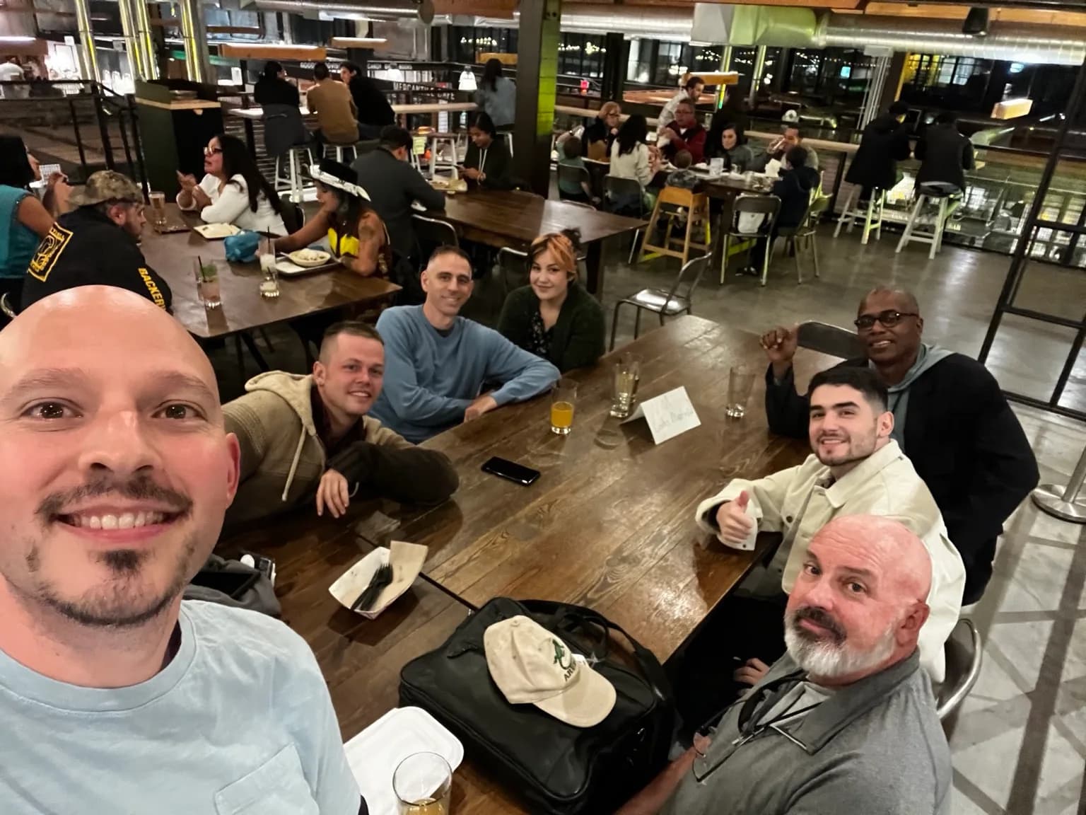 Jim Peterson and software community members gathered around a restaurant table.